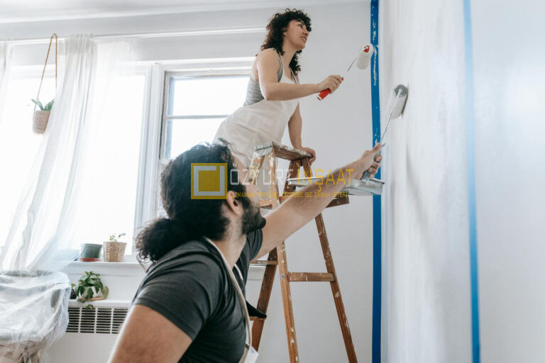 couple painting a wall